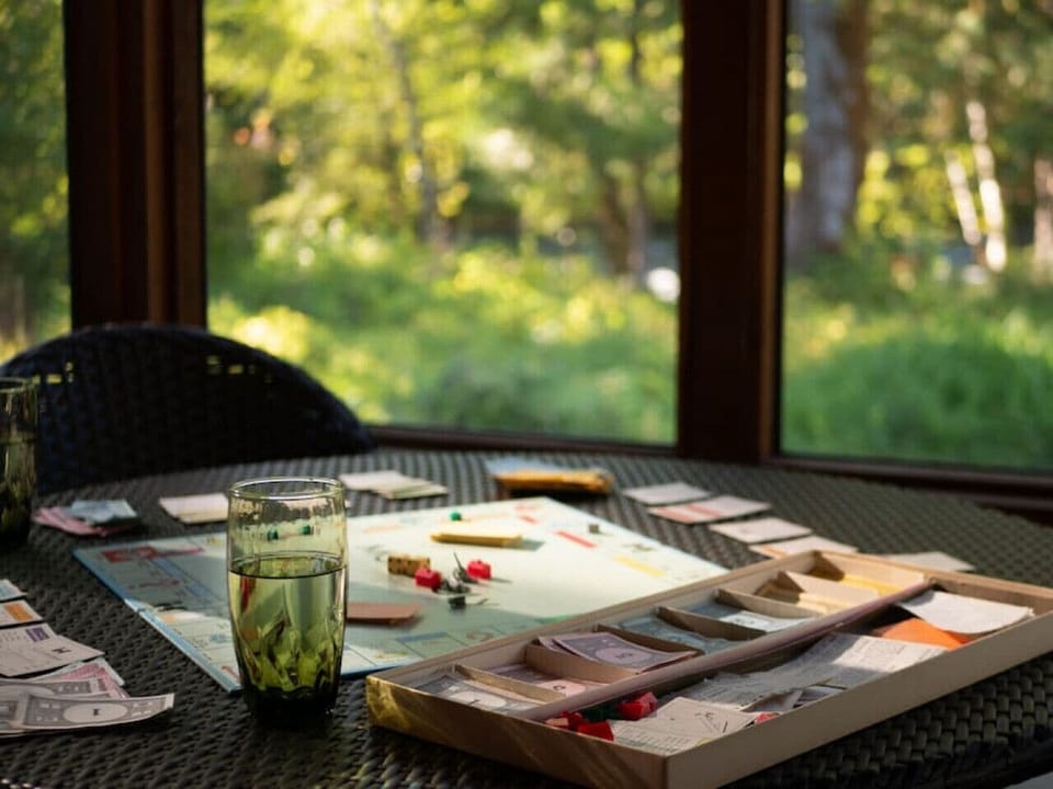 Screened in covered porch with river views, full sectional couch and table for four