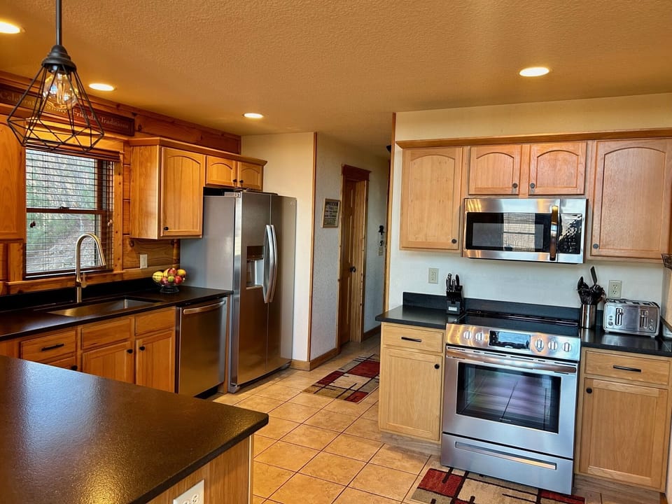 Kitchen is fully equipped with dishes, all cookware, and has new appliances. 