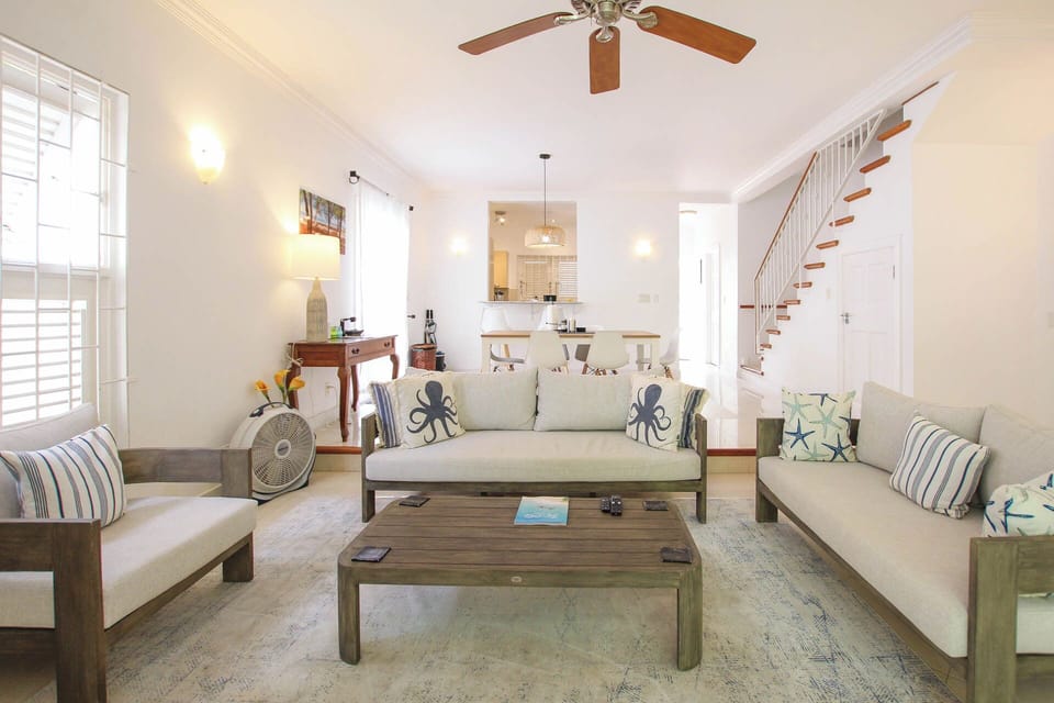 The open living area is kept cool by ceiling fans