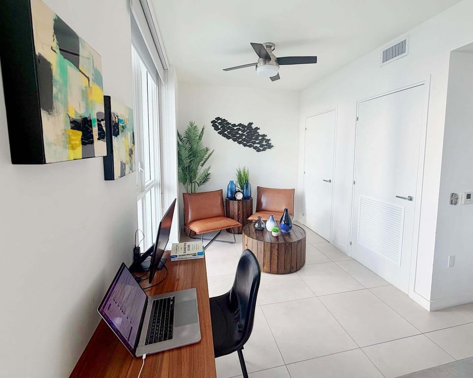Work space area, seating area for two, and balcony access