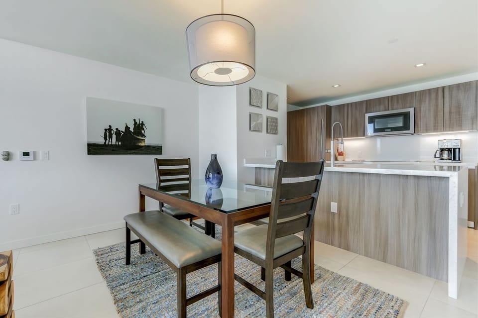 Modern, glass dining table sits four