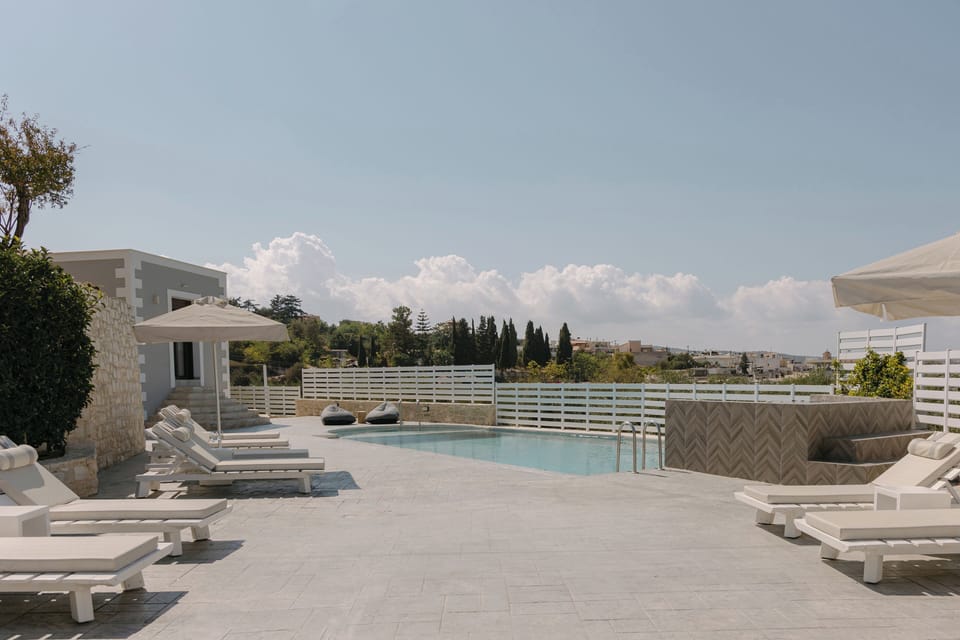Luxurious sunbeds invite slow afternoons beneath the warm Cretan sun.