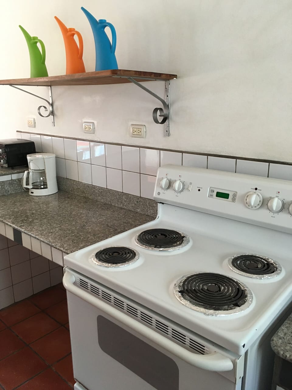 Full size stove, drip coffee maker, microwave, toaster oven + refrigerator