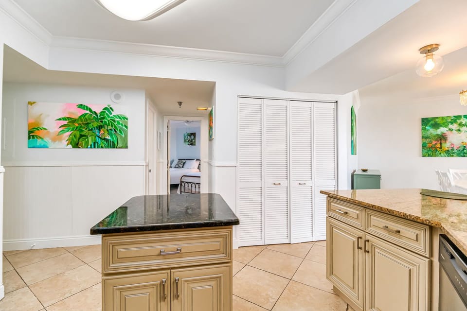 Fully equipped kitchen with granite island and breakfast bar at White Caps beachfront condo