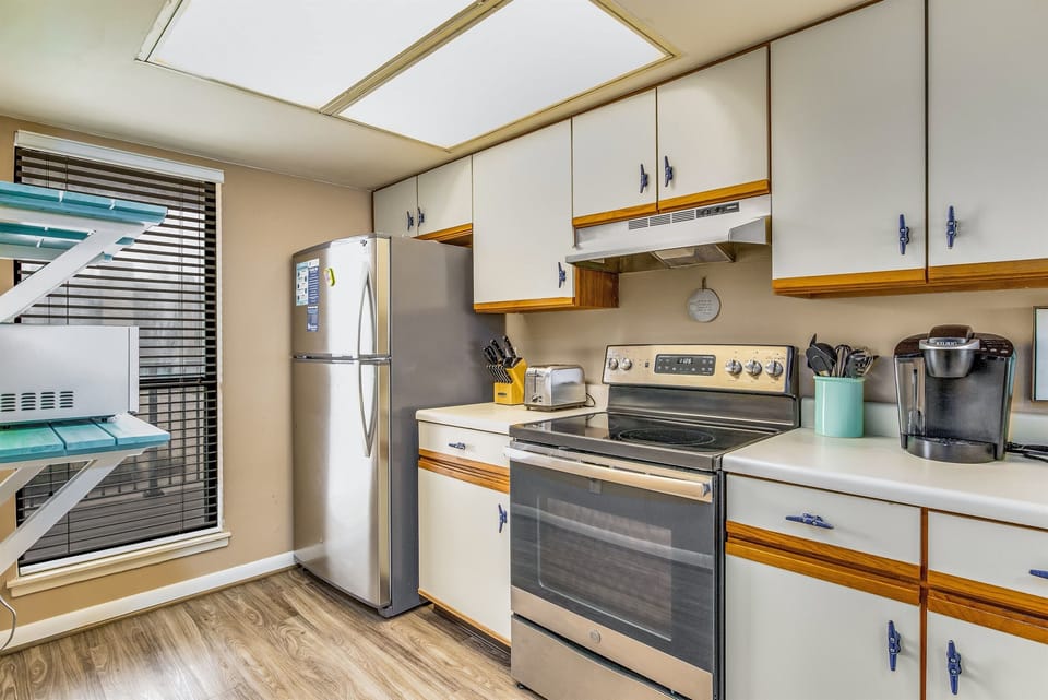 Fully equipped kitchen with stainless appliances and tile countertops at Wind Drift Orange Beach waterfront vacation rental
