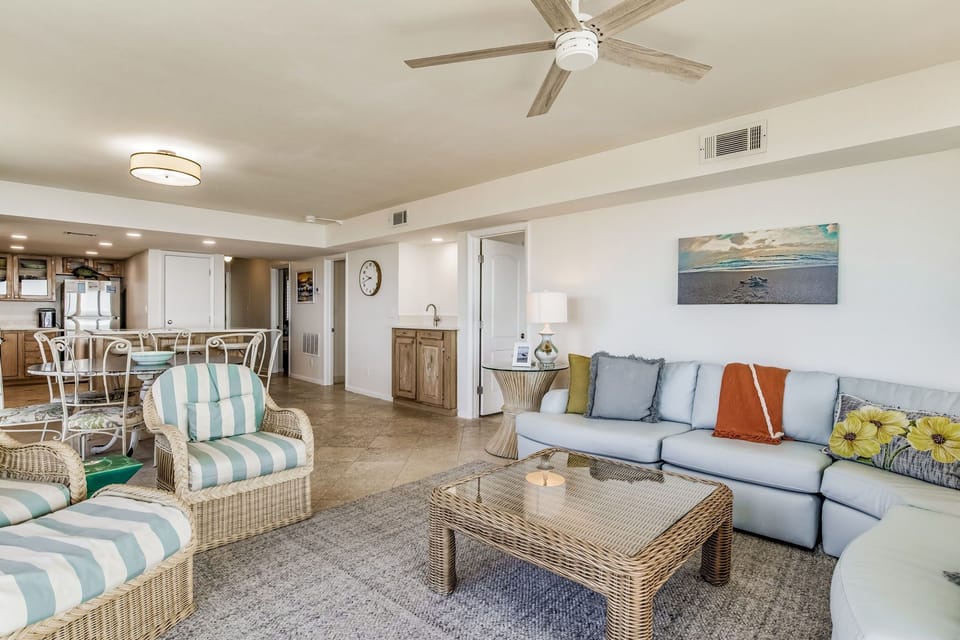 Living room and kitchen with open floor plan at Wind Drift Orange Beach