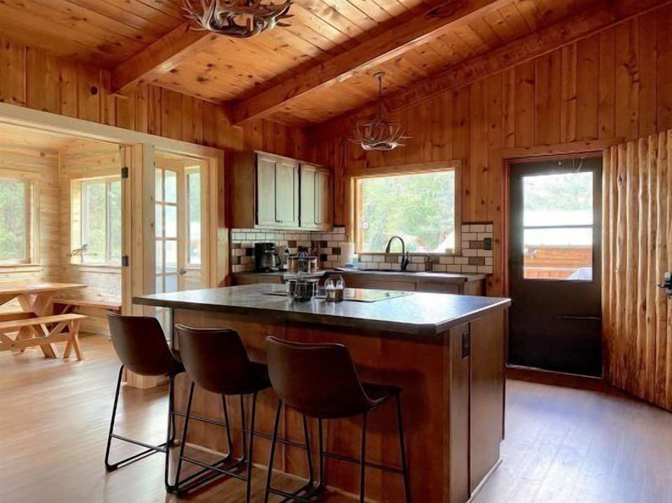 Spacious kitchen with breakfast bar and modern appliances.