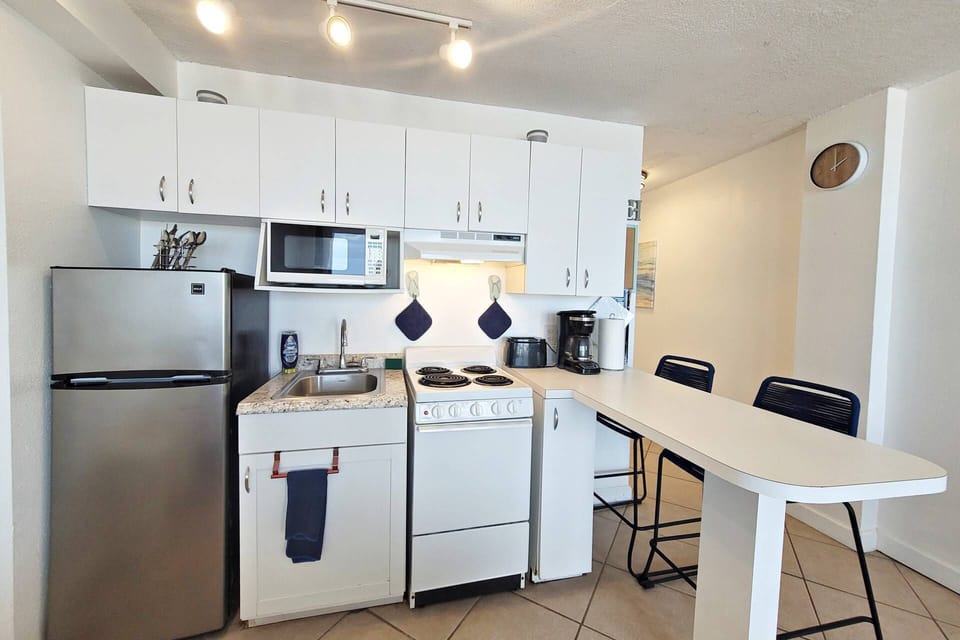 Equipped w/ frig 4 burner stove/oven, microwave, toaster, coffee maker, blender, cookware, plates & utensils.