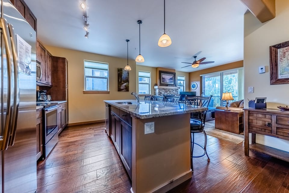 Kitchen - Granite counters, stainless steel appliances, and double sinks.
