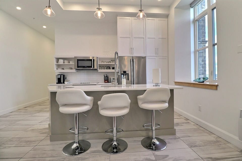 Unit 204 -  Kitchen area with Quartz counter top Island and barstools