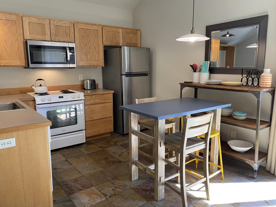 Fully furnished kitchen and dining room for making meals or ordering take out