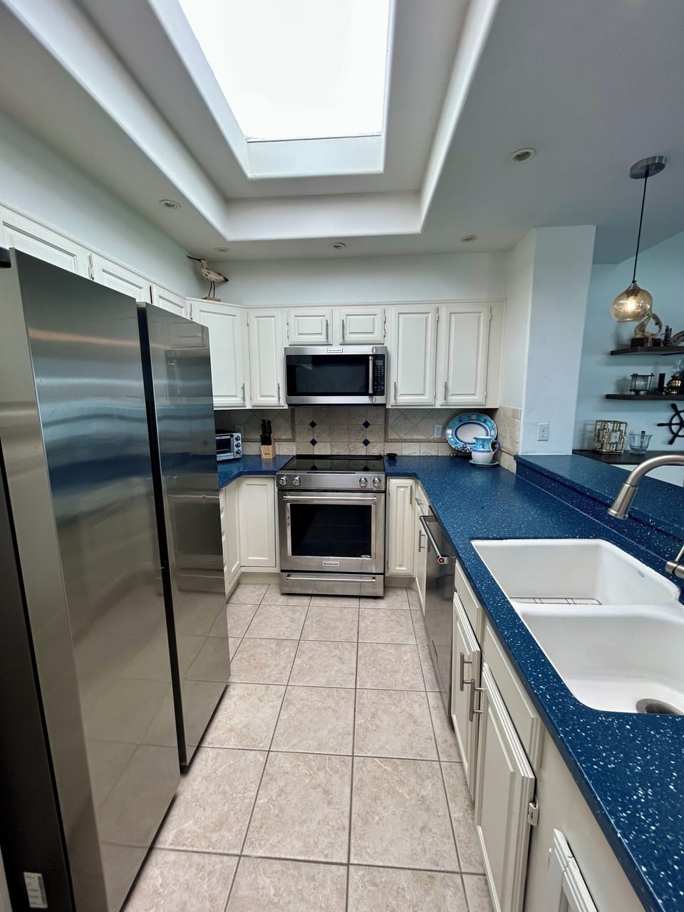 Kitchen aid electric range, microwave and dishwasher.