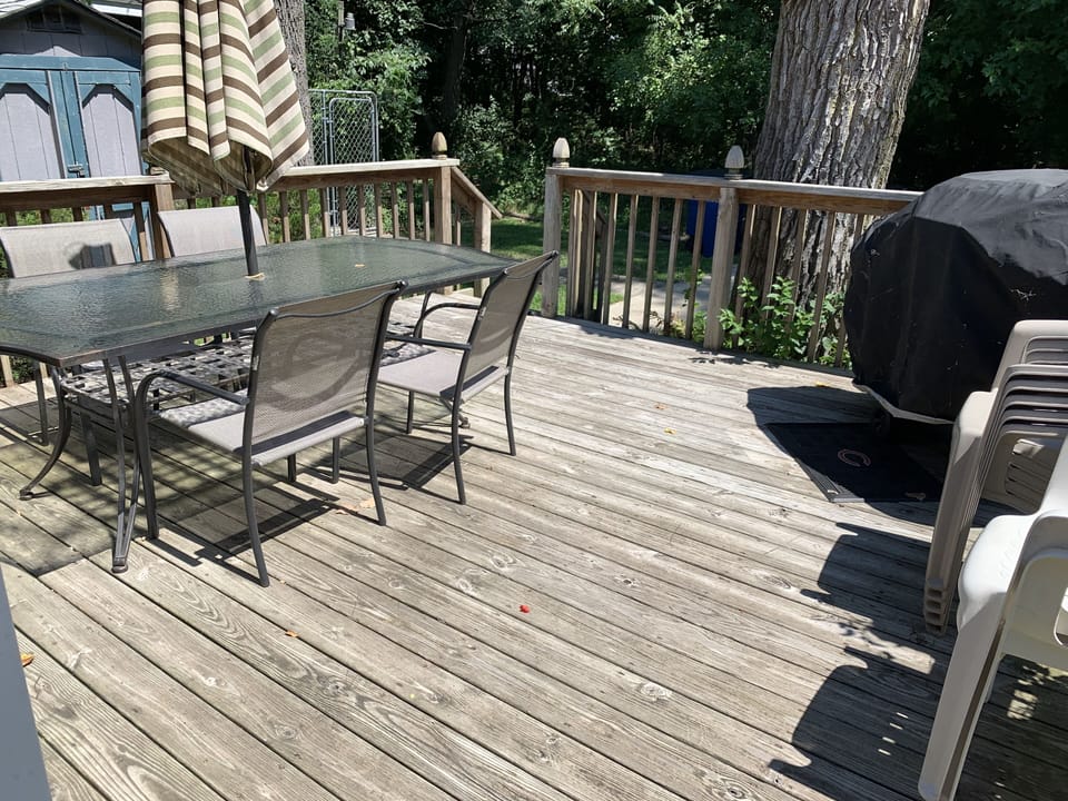 Deck for grilling and patio table and chairs fitting 6 comfortably.