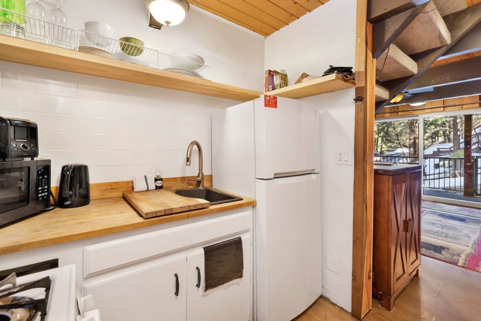 Fully equipped cabin kitchen with ample cabinetry, stove, fridge, microwave, and coffee maker—perfect for cooking meals, morning coffee, and feeling right at home on your stay.