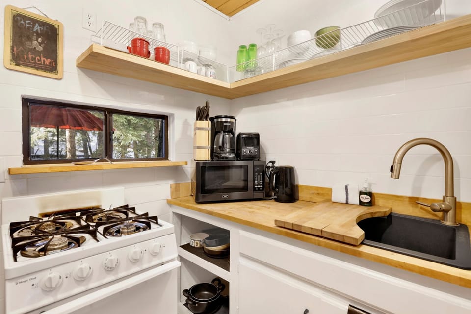 Fully equipped cabin kitchen with ample cabinetry, stove, fridge, microwave, and coffee maker—perfect for cooking meals, morning coffee, and feeling right at home on your stay.