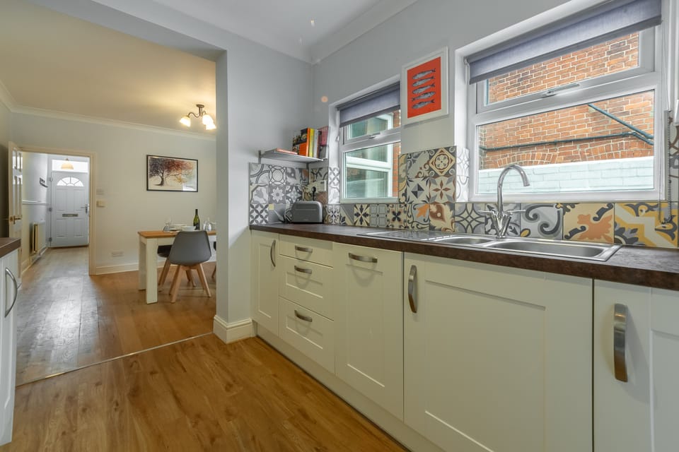 Ground floor: Kitchen, looking back through dining room to hallway and front door