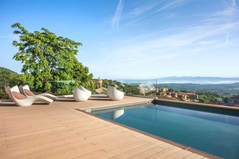 Rooftop seasonal swimming pool with panoramic views of Soriano Nel Cimino’s historic skyline.