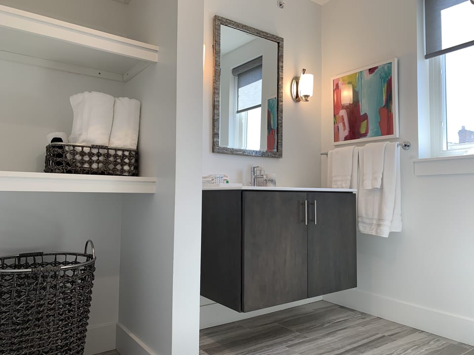 Floating sink and integrated shelving offer loads of storage and functionality. 