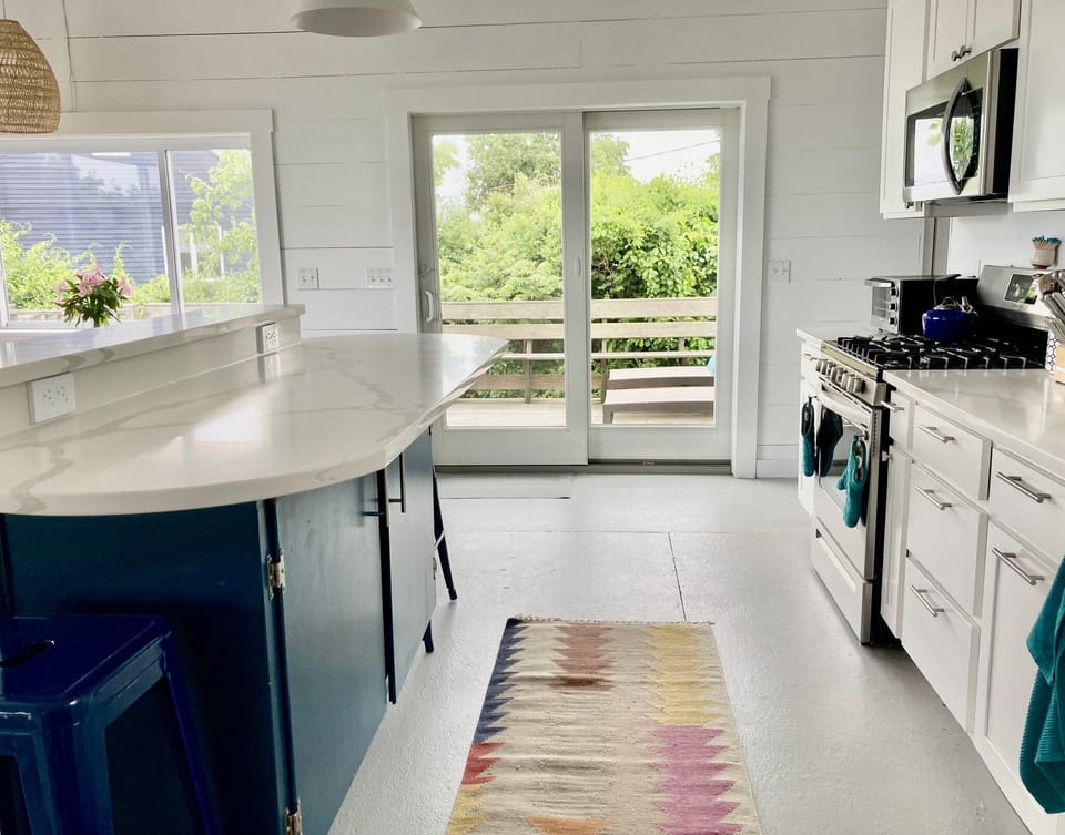 Kitchen with gas stove, dishwasher, island for extra seating/prep, & ocean views