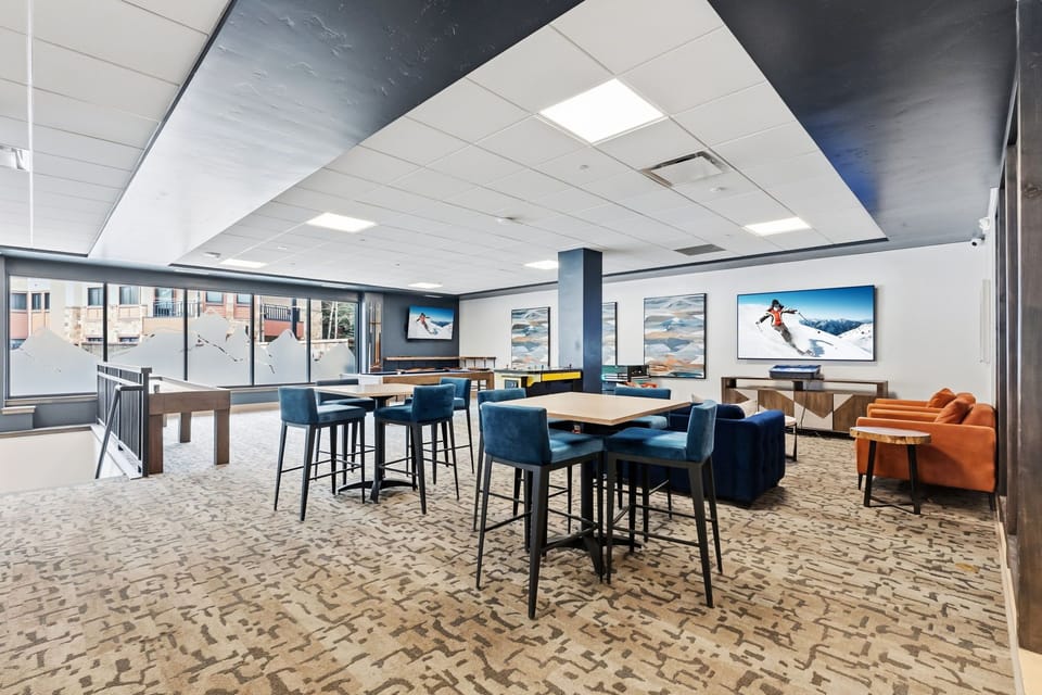 Gather around high-top tables, sink into plush lounge seating, or challenge friends to a game in this vibrant shared space designed for connection and fun.