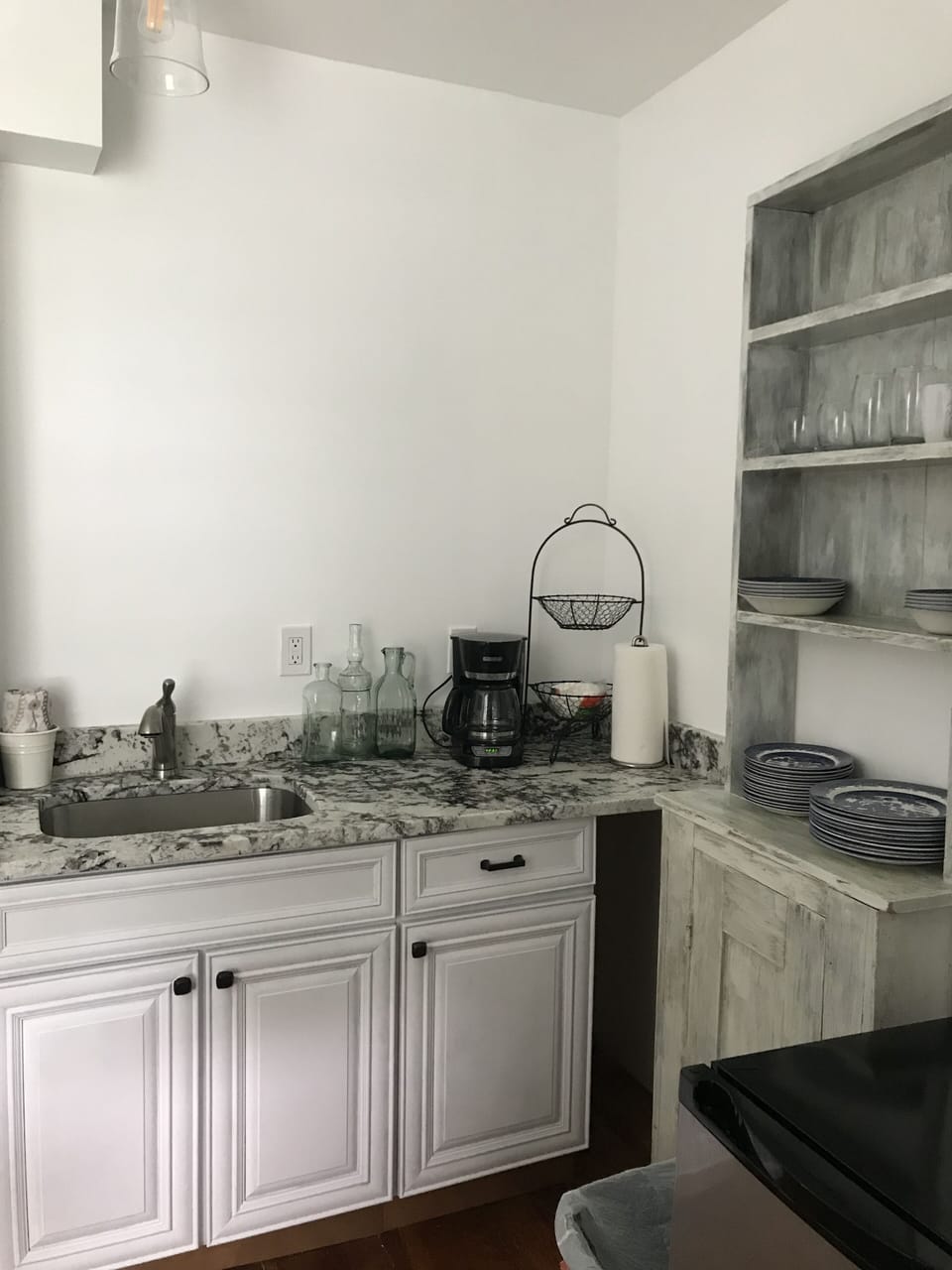 small kitchenette with microwave, refrigerator, electric kettle, convection oven