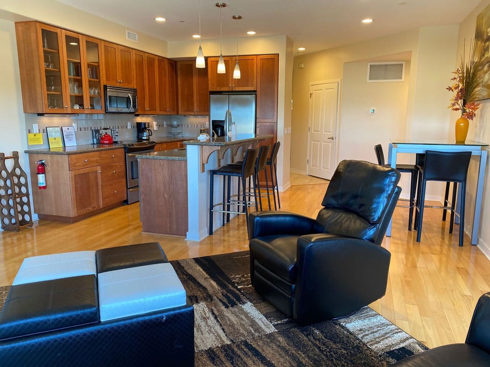 Kitchen with bar seating and adjoining living room