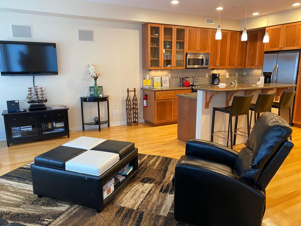 Kitchen with bar seating and adjoining living room