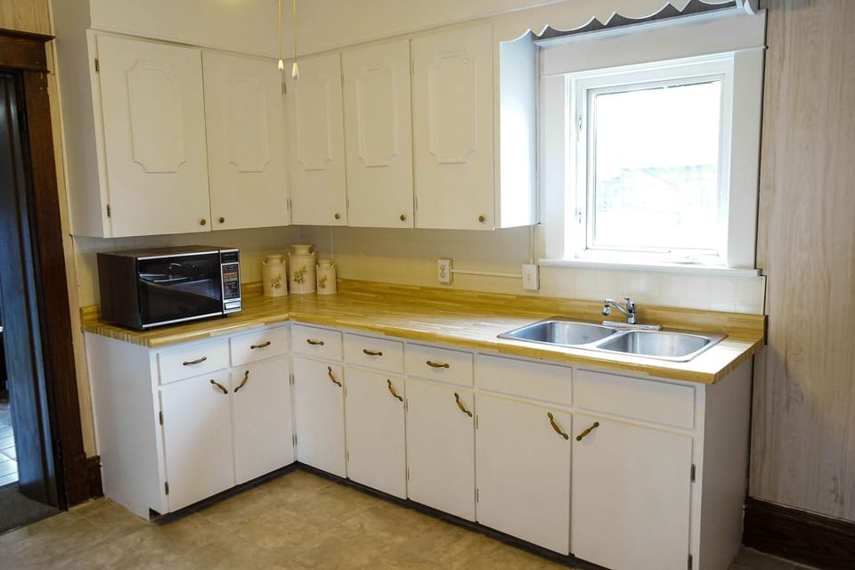 Kitchen area-equipped with toaster, microwave kettle, coffee maker, cooking ware