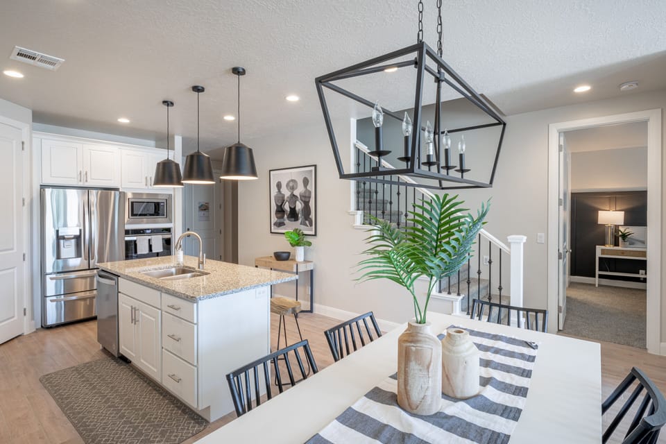 Dining Room View - The Kitchen and Dining Table can accommodate 10 adults and is stocked with pots, pans, baking sheets, mixing bowls, plates, bowls, cups, silverware, and a collection of cooking utensils.