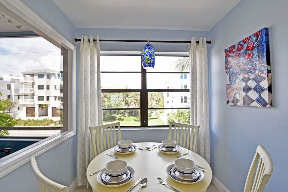 Dining area with table seating and windows overlooking the grounds