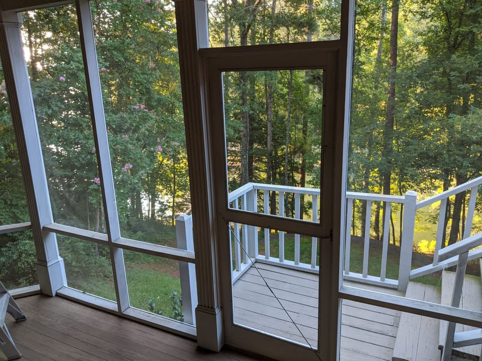 View out of the attached screened porch looking down at the docks.