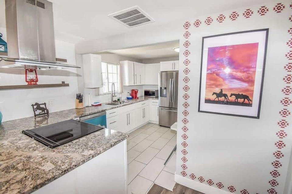 Modern appliances, cookware, and a dining area for home-cooked meals.