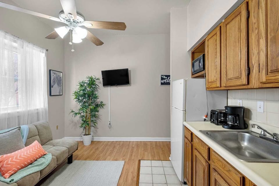 Modern Living Room with Smart TV
Unwind in a cozy living space featuring a mounted flat-screen TV, stylish entertainment console, and a comfy sofa perfect for streaming your favorite shows.