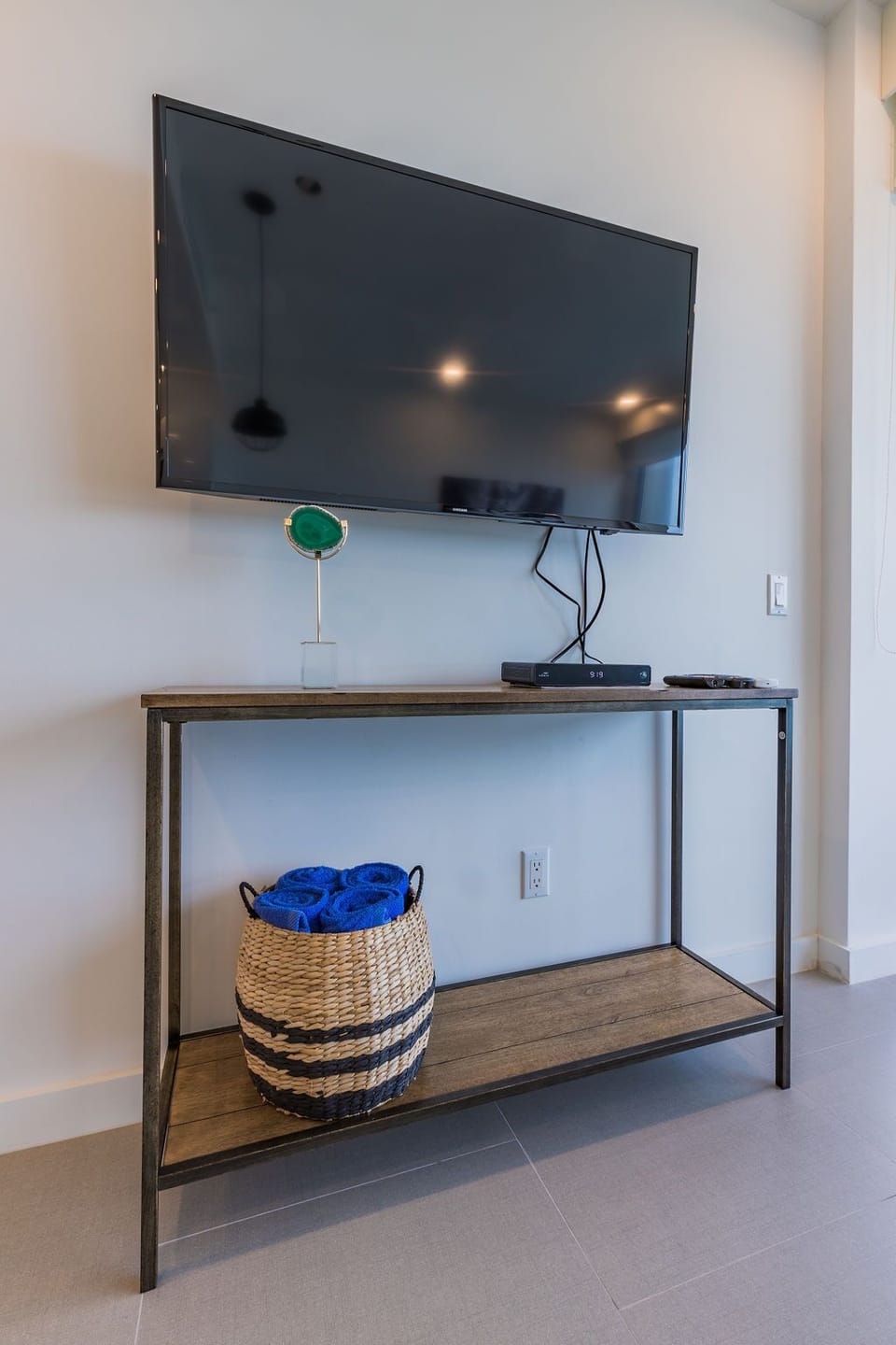 Unwind in your private retreat with a flat-screen TV and thoughtful entertainment setup. Cozy towels are ready in the woven basket, and modern décor adds a welcoming touch to your space.