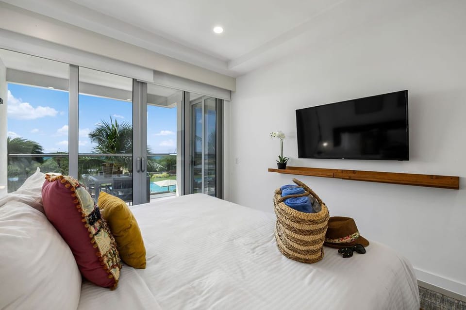 Wake to palm-framed sunshine, step onto your private balcony, and unwind beneath crisp linens with poolside views stretching beyond your terrace doors.