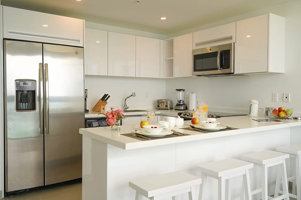 Your modern kitchen offers stainless appliances, a bright breakfast bar, and all the tools you need to savor fresh meals together during your stay.