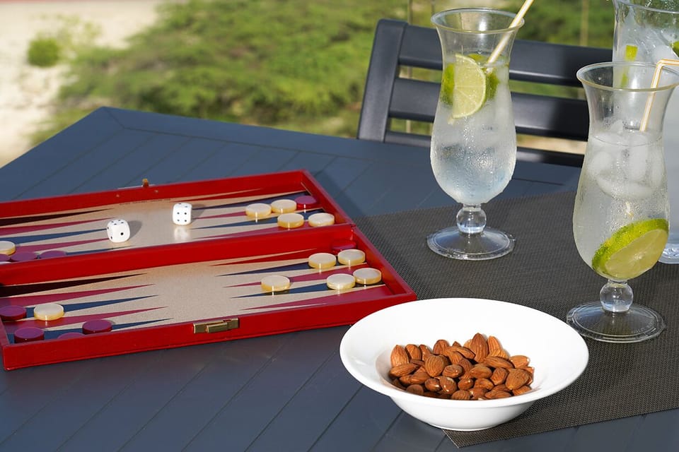 Picture yourself unwinding with refreshing drinks and a friendly game on your private outdoor terrace, surrounded by lush greenery—your perfect retreat awaits.