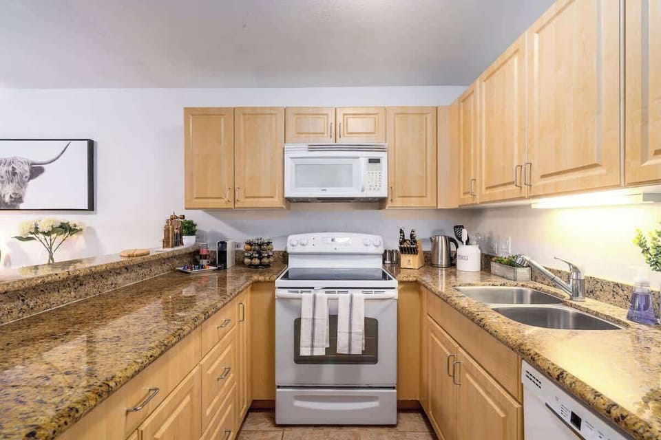 Cook with ease in our fully equipped kitchen, featuring modern appliances and granite countertops.