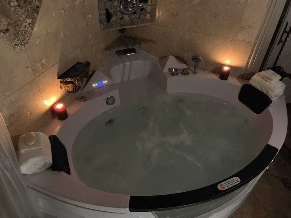 Serenity now! This is a 28 jet Jacuzzi with dimmer switch lit glass block wall