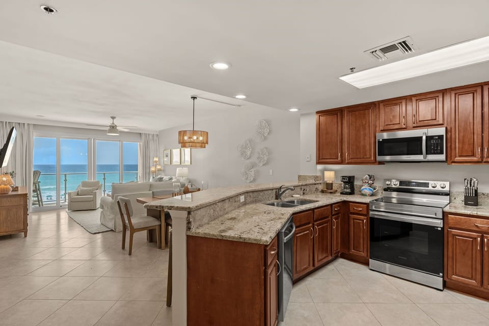 Your fully equipped kitchen flows seamlessly into the living space, with stunning ocean views creating the perfect backdrop for morning coffee.