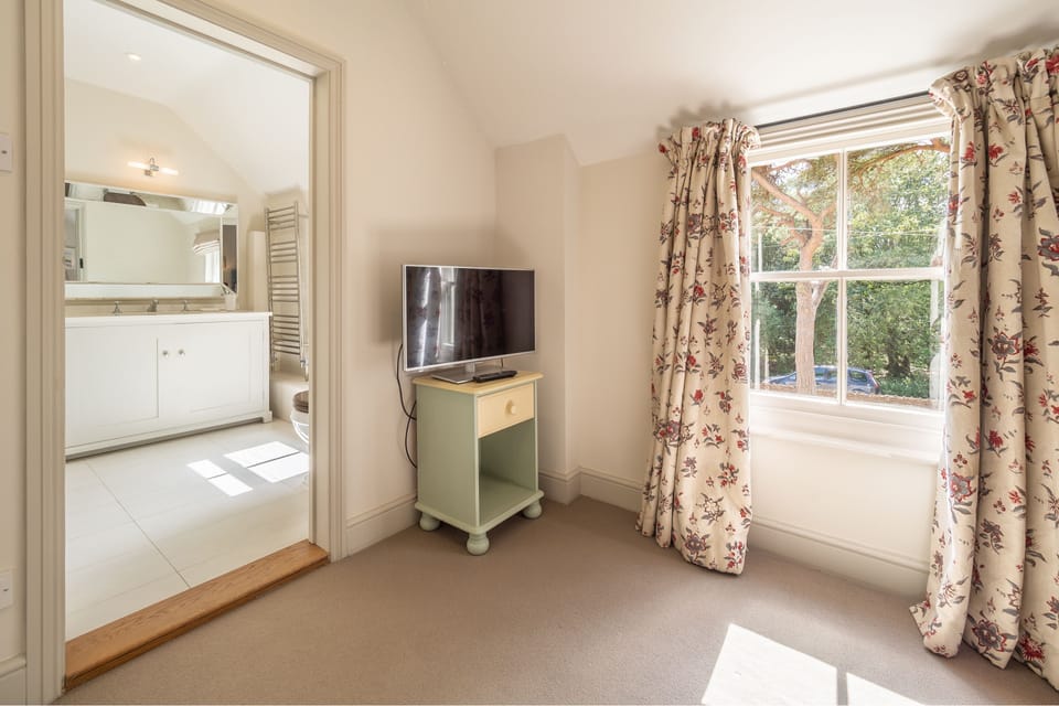 First floor: Master bedroom with television and en-suite bathroom