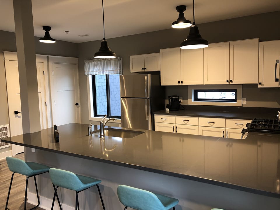 Full-sized kitchen stocked with all essential dishes and utensils.