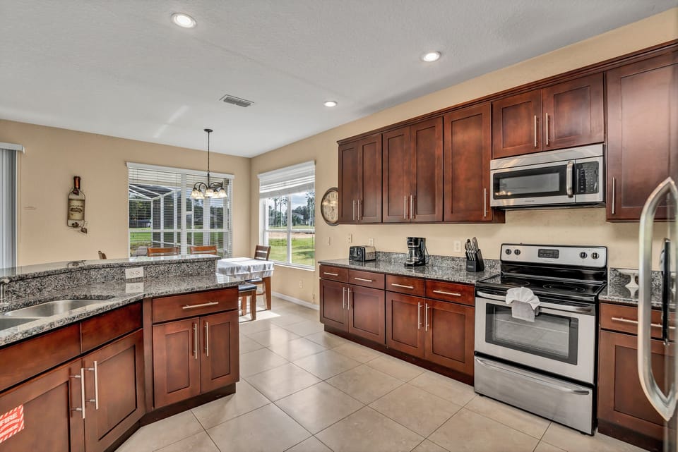 Warm wood cabinetry, stainless steel appliances, and plenty of prep space.