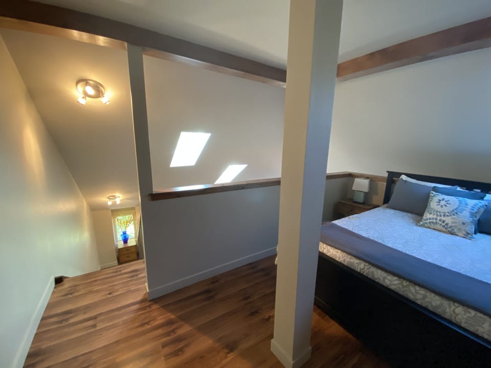 Upper level open loft; queen bed