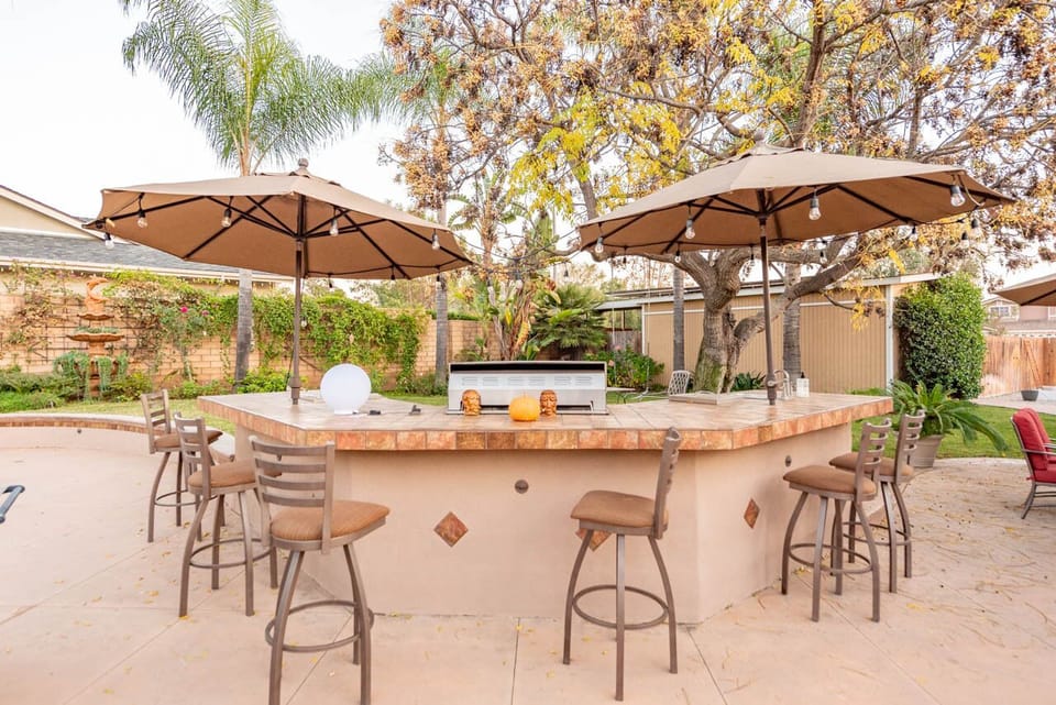 Bar stool, umbrella and BBQ area with lights