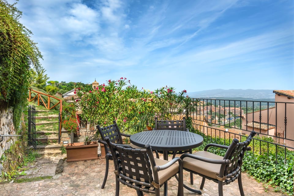 Enjoy breakfast al fresco on a leafy terrace overlooking the rooftops of Soriano nel Cimino.