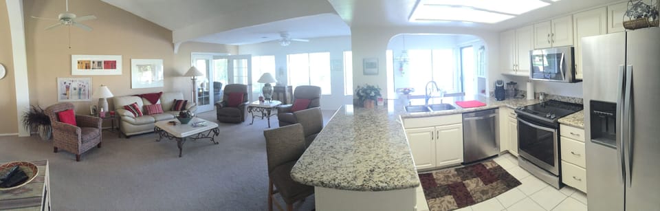 Panoramic view of kitchen and family room, new counter, refrigerator, stove etc