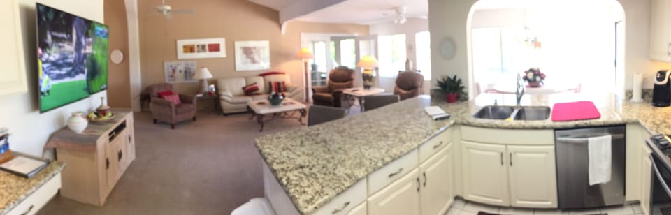 Panoramic view of the kitchen, family room, 75 inch Samsung TV