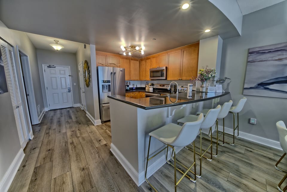 Your spacious kitchen awaits with gleaming countertops, modern appliances, and a perfect breakfast bar where you can sip morning coffee.
