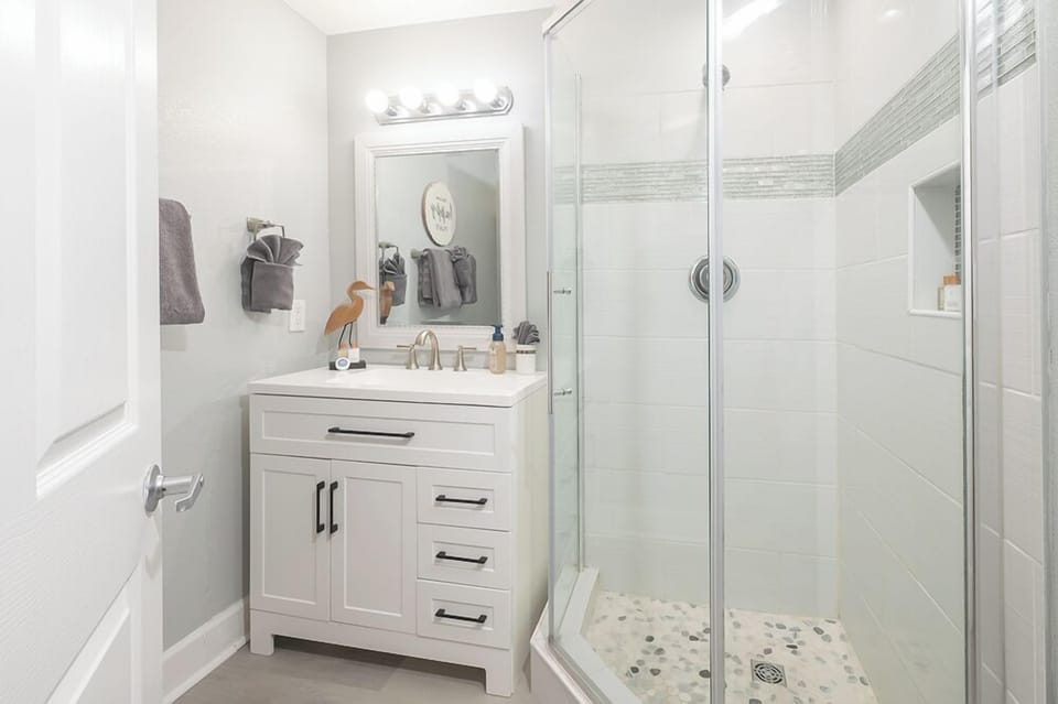 Updated coastal hall bath with walk in shower